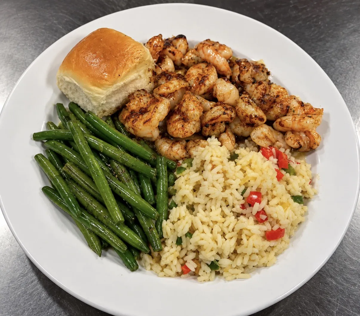 Pan-seared shrimp with rice pilaf, green beans and a dinner roll at Funkheizer's